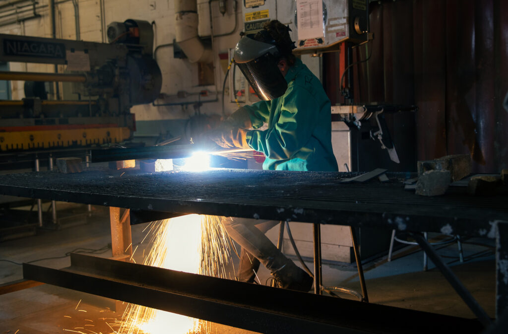 A person welding in a machine shop